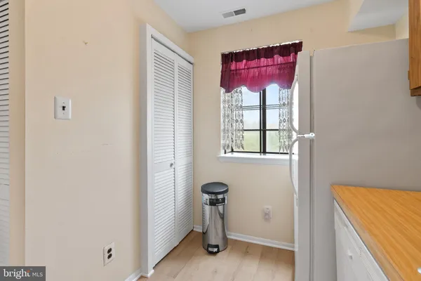 a kitchen with a refrigerator sink and cabinets