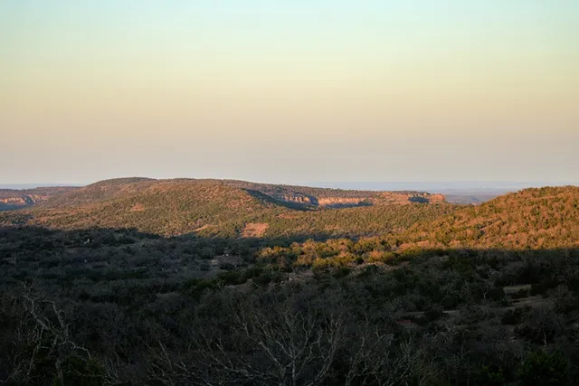 a view of a large mountain with mountains in the background