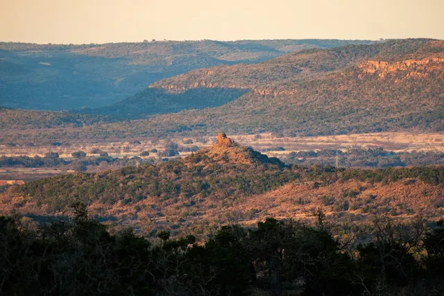 a view of a mountain range with lush green hillside