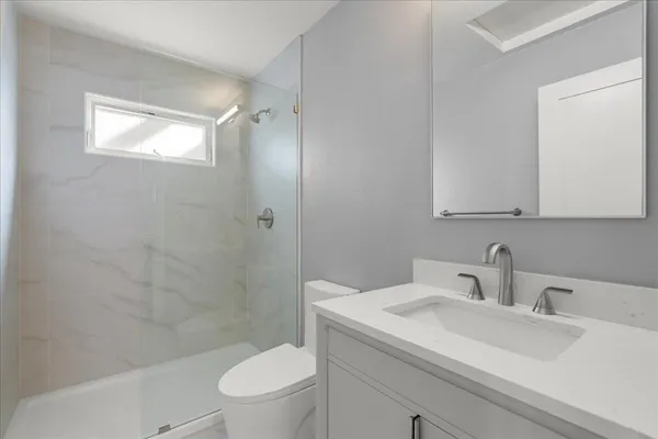 a bathroom with a sink toilet and shower