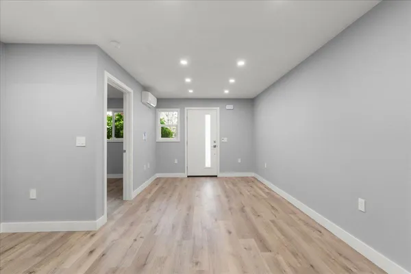 wooden floor in an empty room with a window