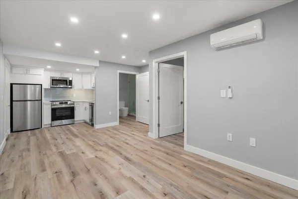 a view of a kitchen with a sink and a refrigerator