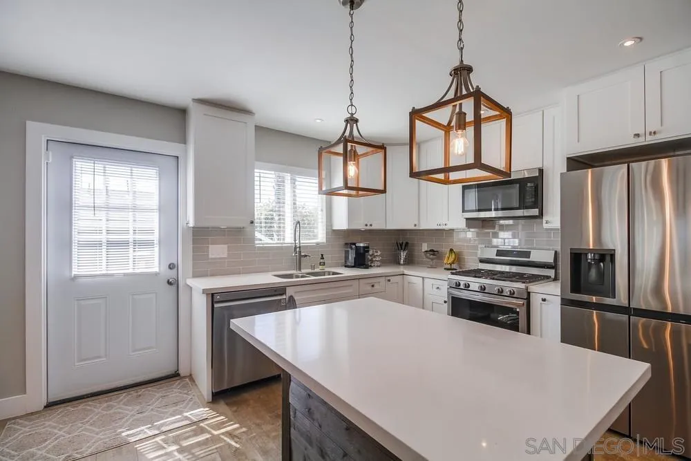730 Pidgeon Street San Diego, CA 92114 - Photo 11 of 39 a kitchen with stainless steel appliances granite countertop a sink a stove a refrigerator cabinets and a window