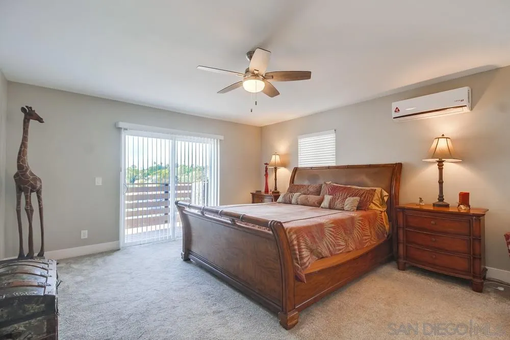 730 Pidgeon Street San Diego, CA 92114 - Photo 15 of 39 a bedroom with a bed and a chandelier