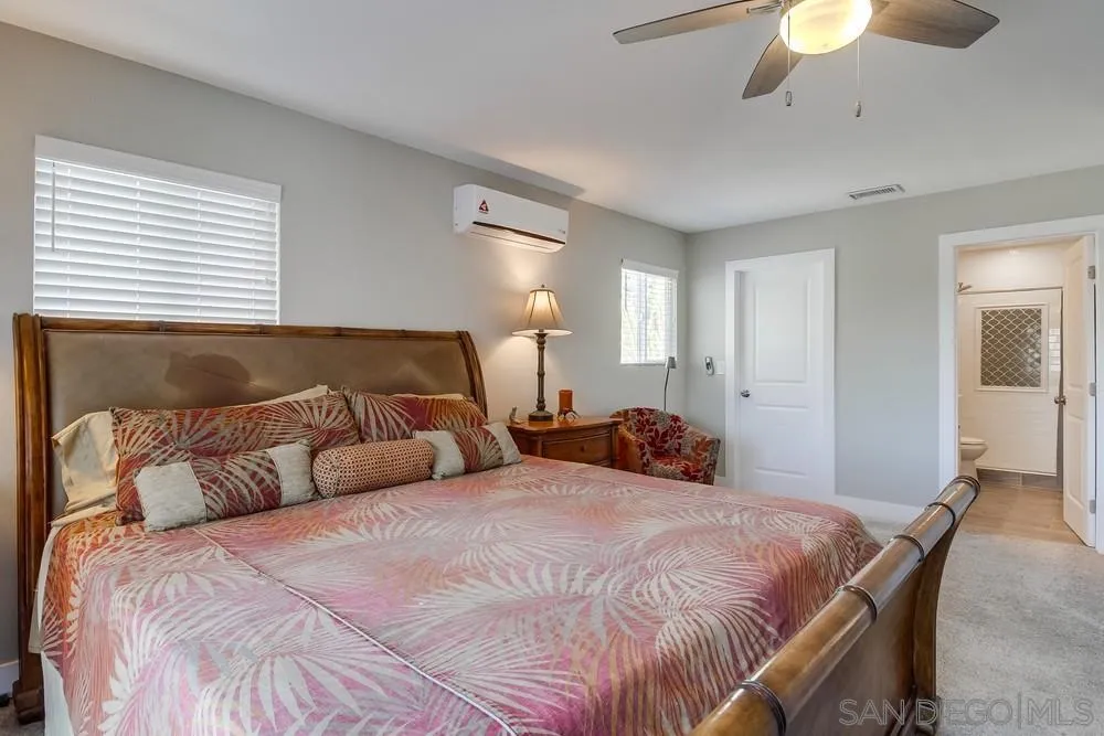 730 Pidgeon Street San Diego, CA 92114 - Photo 17 of 39 a bedroom with a bed and a chandelier