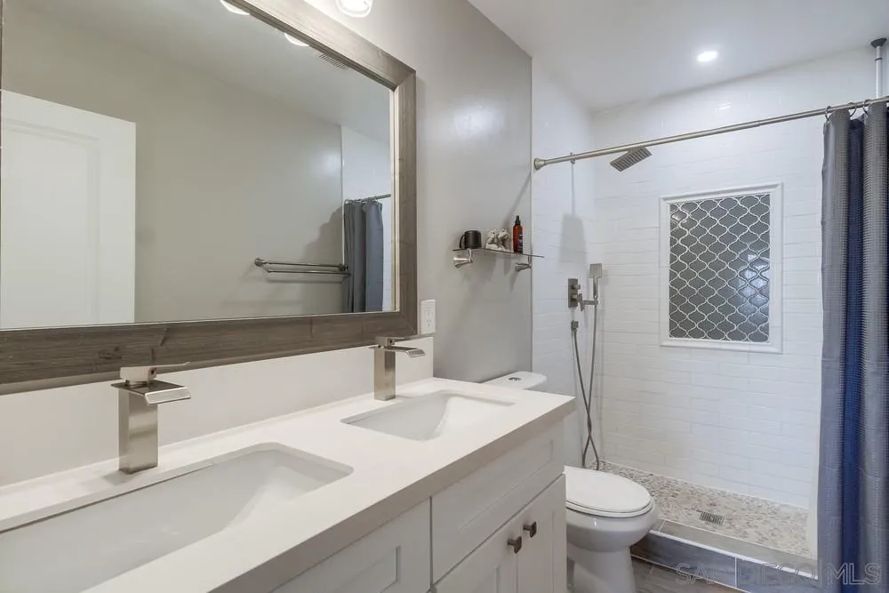 730 Pidgeon Street San Diego, CA 92114 - Photo 19 of 39 a bathroom with a sink toilet double vanity and shower