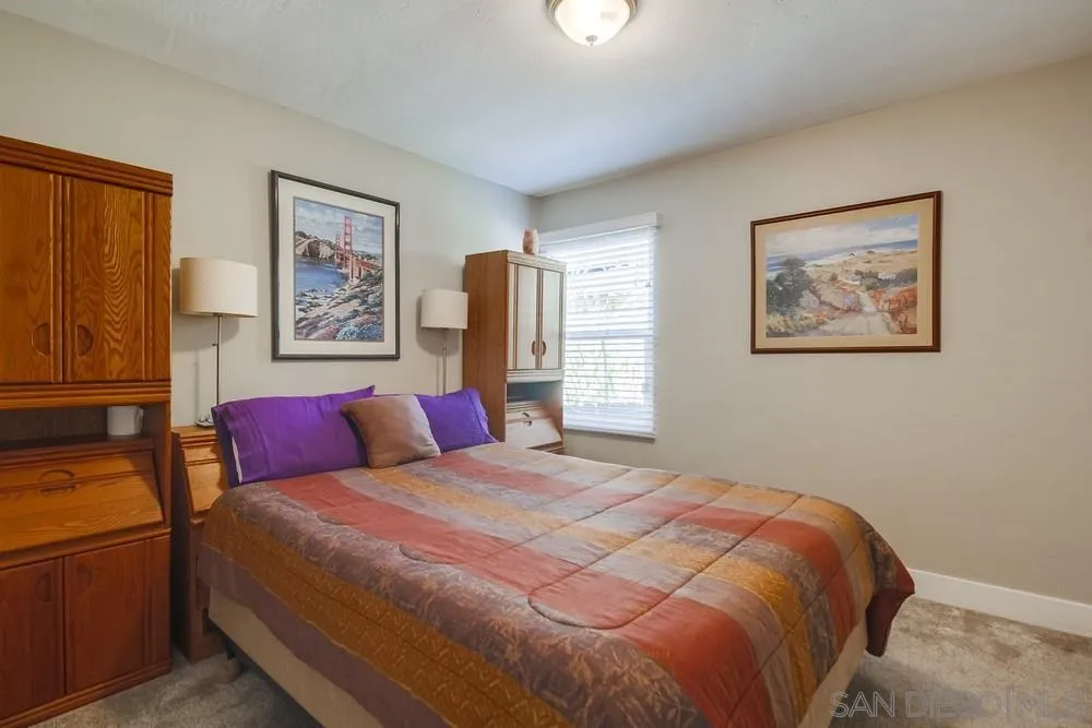 730 Pidgeon Street San Diego, CA 92114 - Photo 21 of 39 a bedroom with a large bed and a painting on the wall