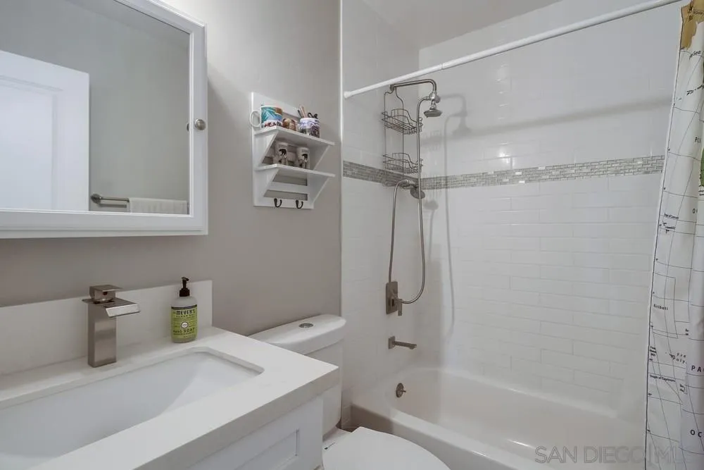 730 Pidgeon Street San Diego, CA 92114 - Photo 27 of 39 a bathroom with a shower a sink and a mirror