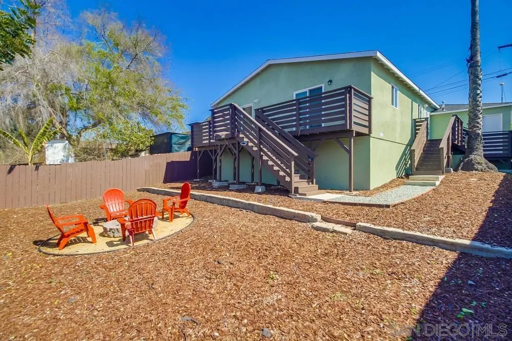 730 Pidgeon Street San Diego, CA 92114 - Photo 32 of 39 a view of a backyard with a small cabin and a chair