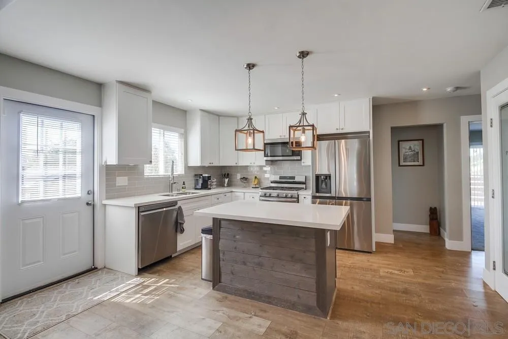 730 Pidgeon Street San Diego, CA 92114 - Photo 10 of 39 a kitchen with kitchen island a sink stove and refrigerator