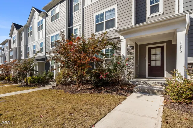 front view of a brick house with a yard