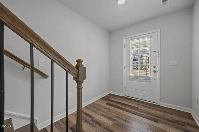 a view of entryway and hall with wooden floor