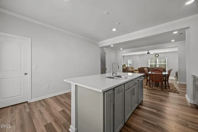 a view of a a dining room with furniture window and wooden floor