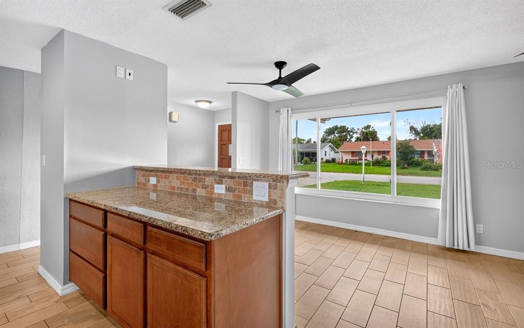 1309 Suwanee Road Daytona Beach, FL 32114 - Photo 9 of 33 a bathroom with a granite countertop sink and a large mirror