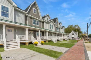 a front view of a building with street view and trees