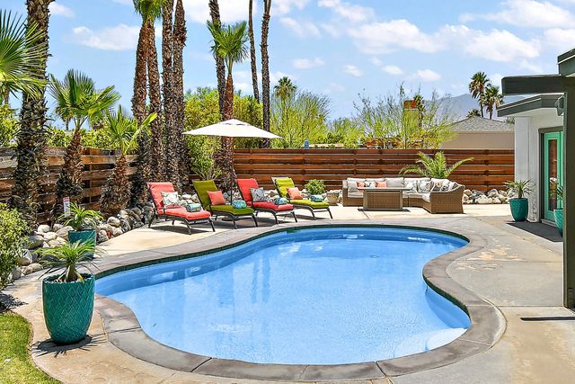 a view of swimming pool with outdoor seating