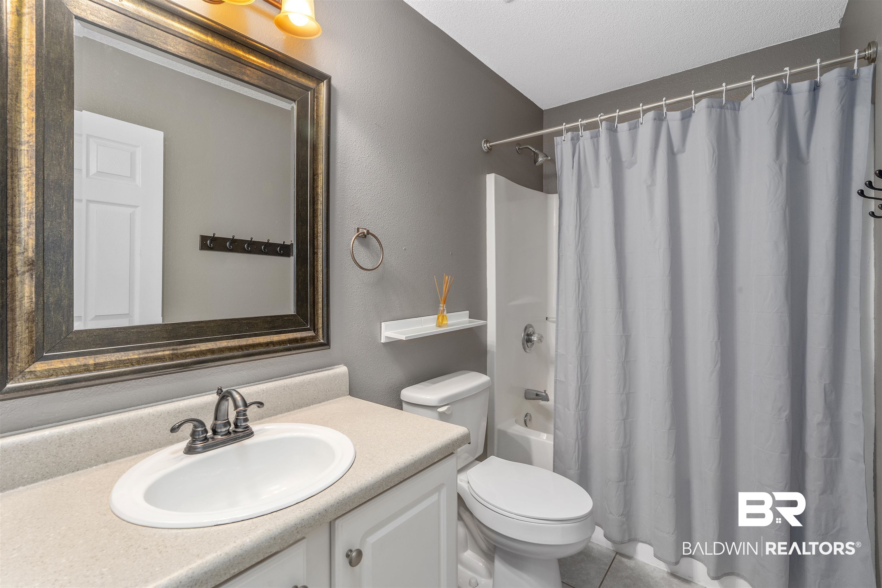 11097 Pontchartrain Loop Daphne, AL 36526 - Photo 23 of 28 Full bathroom with vanity, shower / bath combo with shower curtain, and tile patterned floors