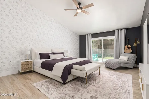 a bedroom with bed couch and window