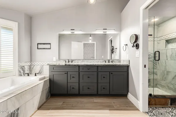 a spacious bathroom with a double vanity sink and a bathtub