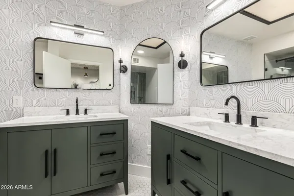 a bathroom with a sink vanity and a mirror