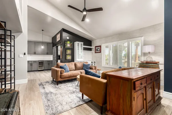a living room with furniture and a ceiling fan