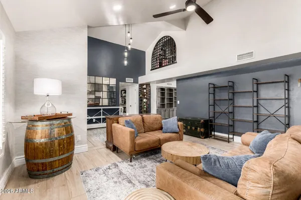 a living room with furniture wooden floor and a large window