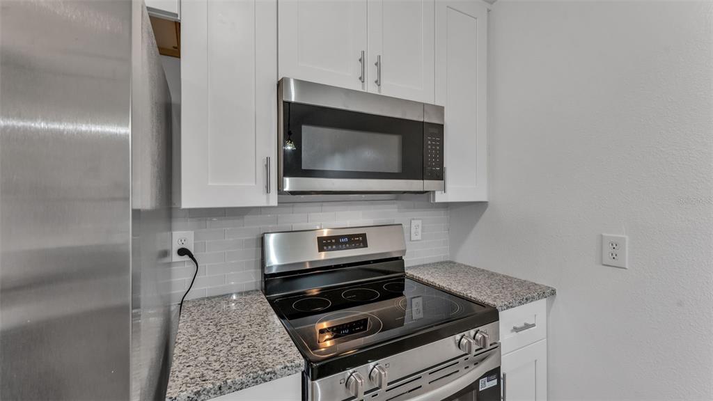 141 Fernery Road, Unit D1 Lakeland, FL 33809 - Photo 5 of 30 a kitchen with a stove and a microwave