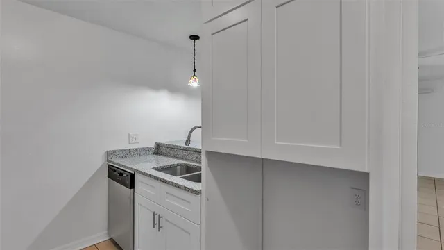 a view of a kitchen with white cabinets