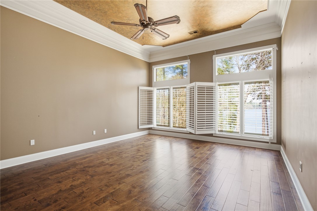 610 Highridge Drive Seneca, SC 29672 - Photo 27 of 50 This spacious bedroom offers beautiful hardwood flooring and large windows for ample natural light.