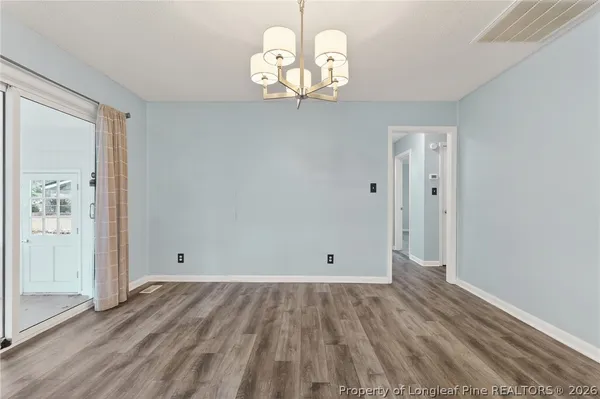 a view of a room with wooden floor and window
