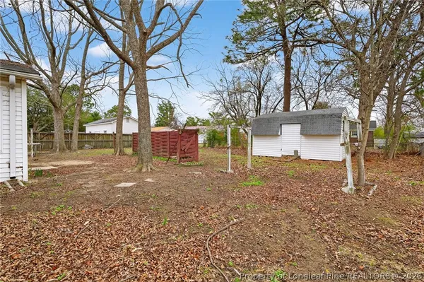 a view of a yard with a house and a tree