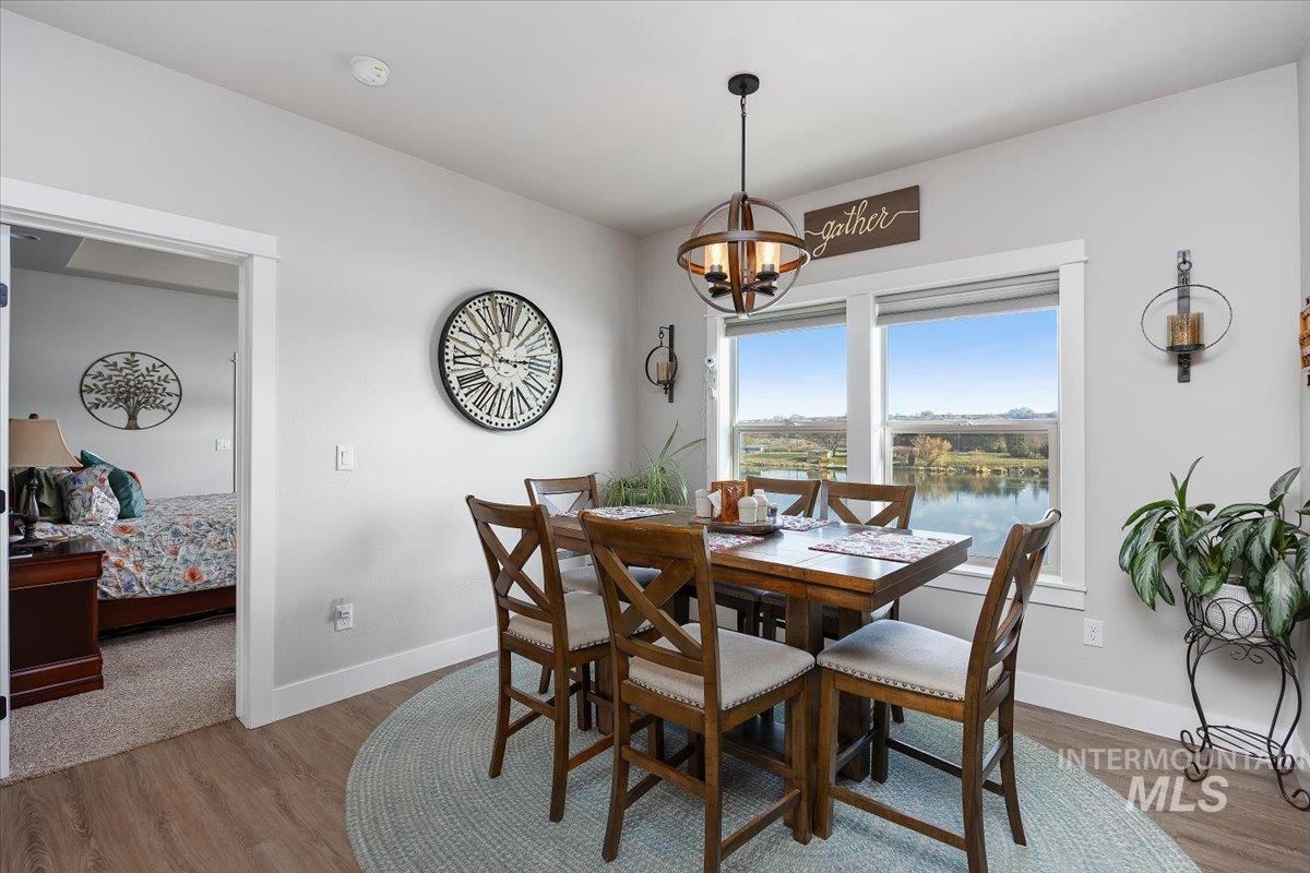 40 Bell Rapids Road Hagerman, ID 83332 - Photo 7 of 50 Dining area with wood finished floors, a water view, and suspended lighting