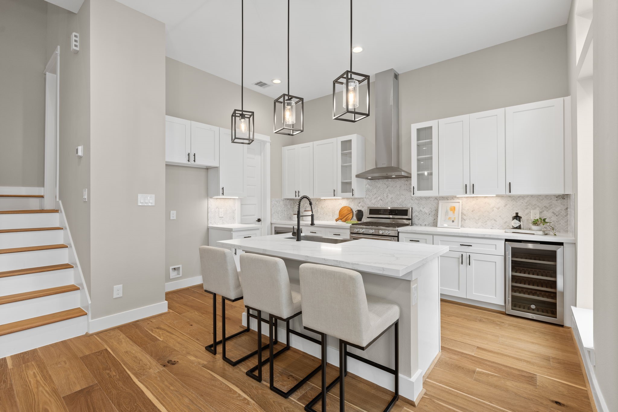 1195 West 19th Street Houston, TX 77008 - Photo 15 of 40 a kitchen with stainless steel appliances white cabinets and wooden floor