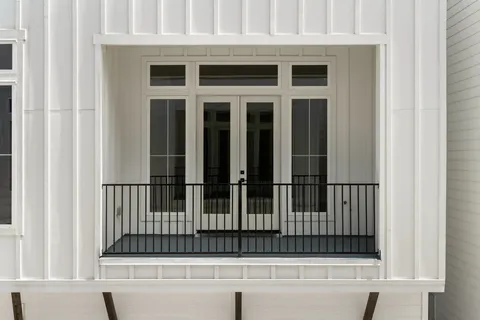 a view of a hallway with wooden floor and entryway