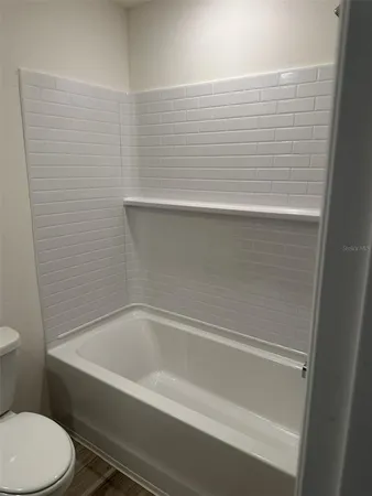 a bathroom with a bathtub and toilet