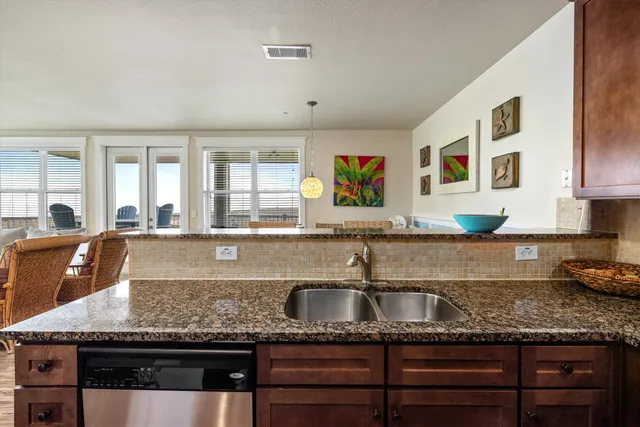 a kitchen with stainless steel appliances granite countertop a refrigerator and a sink