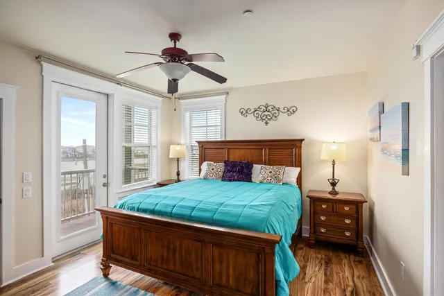 a bedroom with a bed and a view of living room