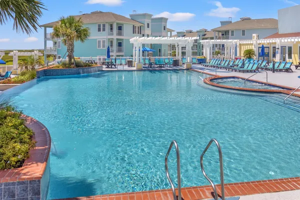 a view of a swimming pool with outdoor seating