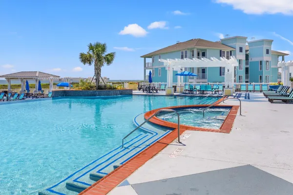 a view of swimming pool with outdoor seating and city view