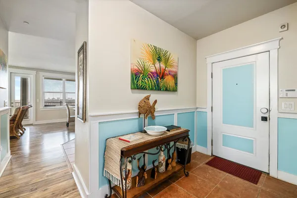 a view of a city from a balcony with chairs