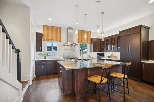 a view of staircase with lots of frames on wall and a window