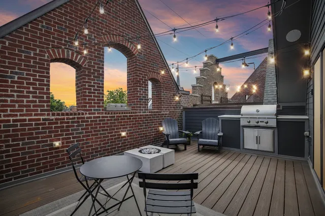 a backyard of a house with barbeque oven table and chairs
