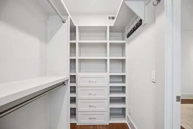 a bathroom with a granite countertop toilet and a sink