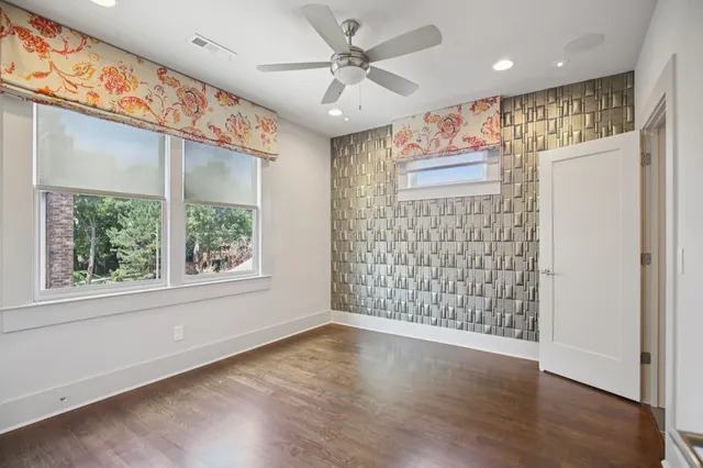 a view of a patio with table and chairs with wooden floor and fence