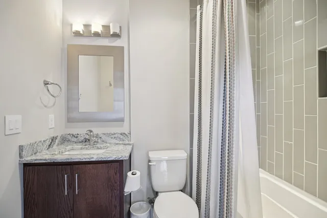 a bathroom with a sink a mirror and shower