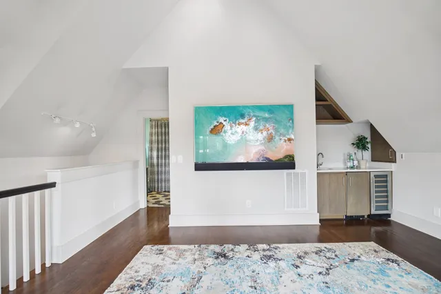 a tall building with a small yard and large trees