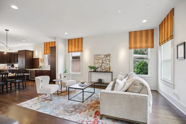 a living room with furniture wooden floor and a potted plant