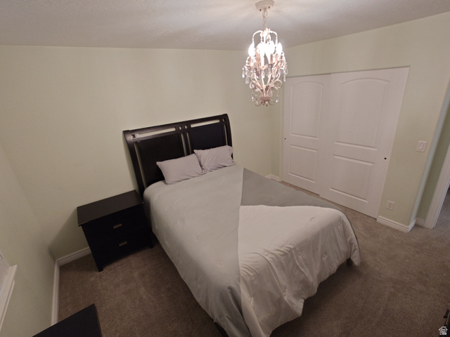 552 Sunset Crest Way Draper, UT 84020 - Photo 33 of 68 Bedroom with a chandelier, carpet, and a closet