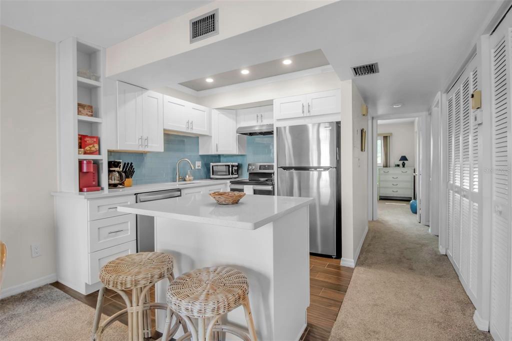 5420 Swift Road, Unit 38 Sarasota, FL 34231 - Photo 11 of 37 a kitchen with stainless steel appliances a refrigerator sink and cabinets