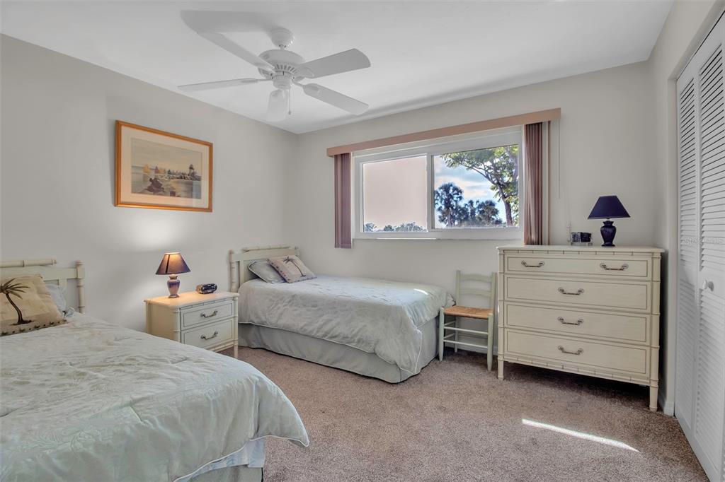 5420 Swift Road, Unit 38 Sarasota, FL 34231 - Photo 20 of 37 a bedroom with two beds and a painting on the wall